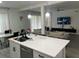 Open-concept kitchen featuring a large center island with white countertops, pendant lighting, and stainless steel appliances at 17614 Woodcrest Way, Clermont, FL 34714