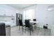 Stylish kitchen featuring white cabinetry, stainless steel appliances and a modern dining area at 17614 Woodcrest Way, Clermont, FL 34714