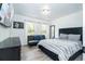 Main bedroom with modern decor, a comfortable bed, TV, and natural light at 17614 Woodcrest Way, Clermont, FL 34714