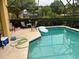 Enclosed pool area with seating and an inflatable raft, perfect for relaxation and outdoor enjoyment at 17614 Woodcrest Way, Clermont, FL 34714