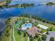 Stunning aerial view of community pool, miniature golf, clubhouse and volleyball court with beautiful lake views at 18309 Oliver Twist Way, Winter Garden, FL 34787