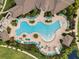 Aerial view of a resort-style community pool with ample lounge seating and lush landscaping at 18309 Oliver Twist Way, Winter Garden, FL 34787