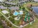 Aerial view of community pool, clubhouse, mini golf, and volleyball, surrounded by green landscaping and trees at 18309 Oliver Twist Way, Winter Garden, FL 34787