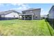 Backyard features a large lawn, a covered patio, and a partial view of the house's exterior at 18309 Oliver Twist Way, Winter Garden, FL 34787
