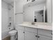 Modern bathroom with a white vanity, shower-tub combination and tile surround at 18309 Oliver Twist Way, Winter Garden, FL 34787