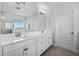 Modern primary bathroom with dual sinks, a large mirror, and a walk-in shower at 18309 Oliver Twist Way, Winter Garden, FL 34787