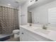 Bright bathroom featuring a double sink vanity with white cabinets and a playful banana-themed shower curtain at 18309 Oliver Twist Way, Winter Garden, FL 34787