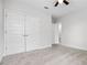 Spacious bedroom with a ceiling fan and large closet with bi-fold doors at 18309 Oliver Twist Way, Winter Garden, FL 34787