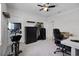 Bedroom with ceiling fan, shelves, workout bike, and a desk at 18309 Oliver Twist Way, Winter Garden, FL 34787