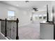 Bright bonus room with plush carpeting, ceiling fan, and natural light from the multiple windows at 18309 Oliver Twist Way, Winter Garden, FL 34787