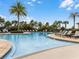 Beautiful community pool with lounge chairs, palm trees and shallow entry with water features at 18309 Oliver Twist Way, Winter Garden, FL 34787