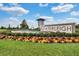 Welcome to Waterleigh! Beautiful entrance with stone monument, water feature, and colorful landscaping at 18309 Oliver Twist Way, Winter Garden, FL 34787