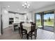 Bright kitchen features white cabinetry, an island with seating, and sliding doors to the patio at 18309 Oliver Twist Way, Winter Garden, FL 34787