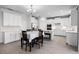 Bright kitchen with white cabinets, stainless steel appliances, and a dining area at 18309 Oliver Twist Way, Winter Garden, FL 34787