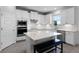 Gourmet kitchen features a large island with breakfast bar seating and stainless steel appliances at 18309 Oliver Twist Way, Winter Garden, FL 34787