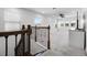 Upstairs living room with carpet, railing, large TV and plentiful natural light at 18309 Oliver Twist Way, Winter Garden, FL 34787