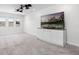 Carpeted living room with large TV and wall unit at 18309 Oliver Twist Way, Winter Garden, FL 34787