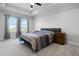 Spacious main bedroom with large windows and a tray ceiling at 18309 Oliver Twist Way, Winter Garden, FL 34787