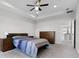 Tranquil main bedroom showcasing tray ceilings, plush carpet, and neutral tones at 18309 Oliver Twist Way, Winter Garden, FL 34787