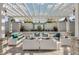 Inviting outdoor lounge featuring comfortable white wicker furniture and a stylish pergola at 18309 Oliver Twist Way, Winter Garden, FL 34787
