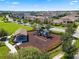 Aerial view of a community playground with slides, swing set, picnic pavilion, and surrounding neighborhood homes at 18309 Oliver Twist Way, Winter Garden, FL 34787