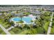 Aerial view of the resort style pool and amenity center surrounded by palm trees and lounge chairs at 18309 Oliver Twist Way, Winter Garden, FL 34787