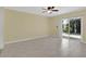 Bedroom features light tile floors and sliding glass door to the exterior at 2020 Royal Bay Blvd # 91, Kissimmee, FL 34746