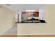 Modern kitchen featuring stainless steel appliances, sleek countertops, and a breakfast bar offering a stylish and functional cooking space at 2020 Royal Bay Blvd # 91, Kissimmee, FL 34746