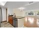Open-concept kitchen with a breakfast bar, stainless steel appliances, and dark cabinets creating a modern and inviting space at 2020 Royal Bay Blvd # 91, Kissimmee, FL 34746