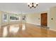 Bright living room with hardwood floors, large windows providing natural light, and a ceiling fan for added comfort at 2020 Royal Bay Blvd # 91, Kissimmee, FL 34746