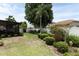 Spacious backyard featuring a patio, lush lawn, and a well-maintained garden area at 2021 Wildfire Ct, Apopka, FL 32703
