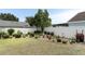 Expansive backyard with well-maintained lawn, manicured landscaping, and mature shade trees at 2021 Wildfire Ct, Apopka, FL 32703