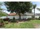 Manicured backyard featuring lush greenery, a lovely garden area and mature trees at 2021 Wildfire Ct, Apopka, FL 32703