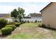 Large backyard offers ample green space with lush landscaping and tranquil surroundings at 2021 Wildfire Ct, Apopka, FL 32703