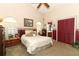 Comfortable bedroom with a ceiling fan, closet and ensuite bath access at 2021 Wildfire Ct, Apopka, FL 32703