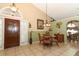Dining area with a glass-top table and views into living room at 2021 Wildfire Ct, Apopka, FL 32703