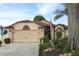 Charming single-story home with a two-car garage, lovely landscaping, and an inviting entryway at 2021 Wildfire Ct, Apopka, FL 32703