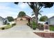 Charming single-Gathering home featuring a well-manicured lawn, mature landscaping, and a two-car garage at 2021 Wildfire Ct, Apopka, FL 32703