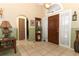 Welcoming foyer with tile flooring and a decorative mirror and table at 2021 Wildfire Ct, Apopka, FL 32703