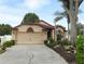 Charming single-story home with a well-maintained lawn and a two-car garage at 2021 Wildfire Ct, Apopka, FL 32703