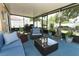 Charming screened-in patio with plush seating, a stone water feature, and backyard views at 2021 Wildfire Ct, Apopka, FL 32703