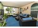 Relaxing screened-in patio with stylish wicker furniture and beautiful plants and view of the yard at 2021 Wildfire Ct, Apopka, FL 32703