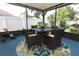 Covered screened patio with outdoor dining area and furniture at 2021 Wildfire Ct, Apopka, FL 32703