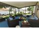 Covered screened patio with lounge seating and garden views at 2021 Wildfire Ct, Apopka, FL 32703