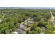 Aerial view of home on large lot surrounded by lush trees at 215 Bradbury Ave, Oak Hill, FL 32759
