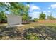 Expansive backyard features storage shed, chicken coop, and mature trees at 215 Bradbury Ave, Oak Hill, FL 32759