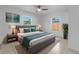 A staged bedroom with a ceiling fan and modern decor at 215 Bradbury Ave, Oak Hill, FL 32759