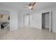 Bright bedroom boasts neutral paint, ceiling fan, and ensuite bath at 215 Bradbury Ave, Oak Hill, FL 32759