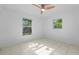 Sunlit room with a ceiling fan and two windows at 215 Bradbury Ave, Oak Hill, FL 32759