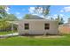 Bright exterior of a well-maintained single-story home with a lush lawn at 215 Bradbury Ave, Oak Hill, FL 32759
